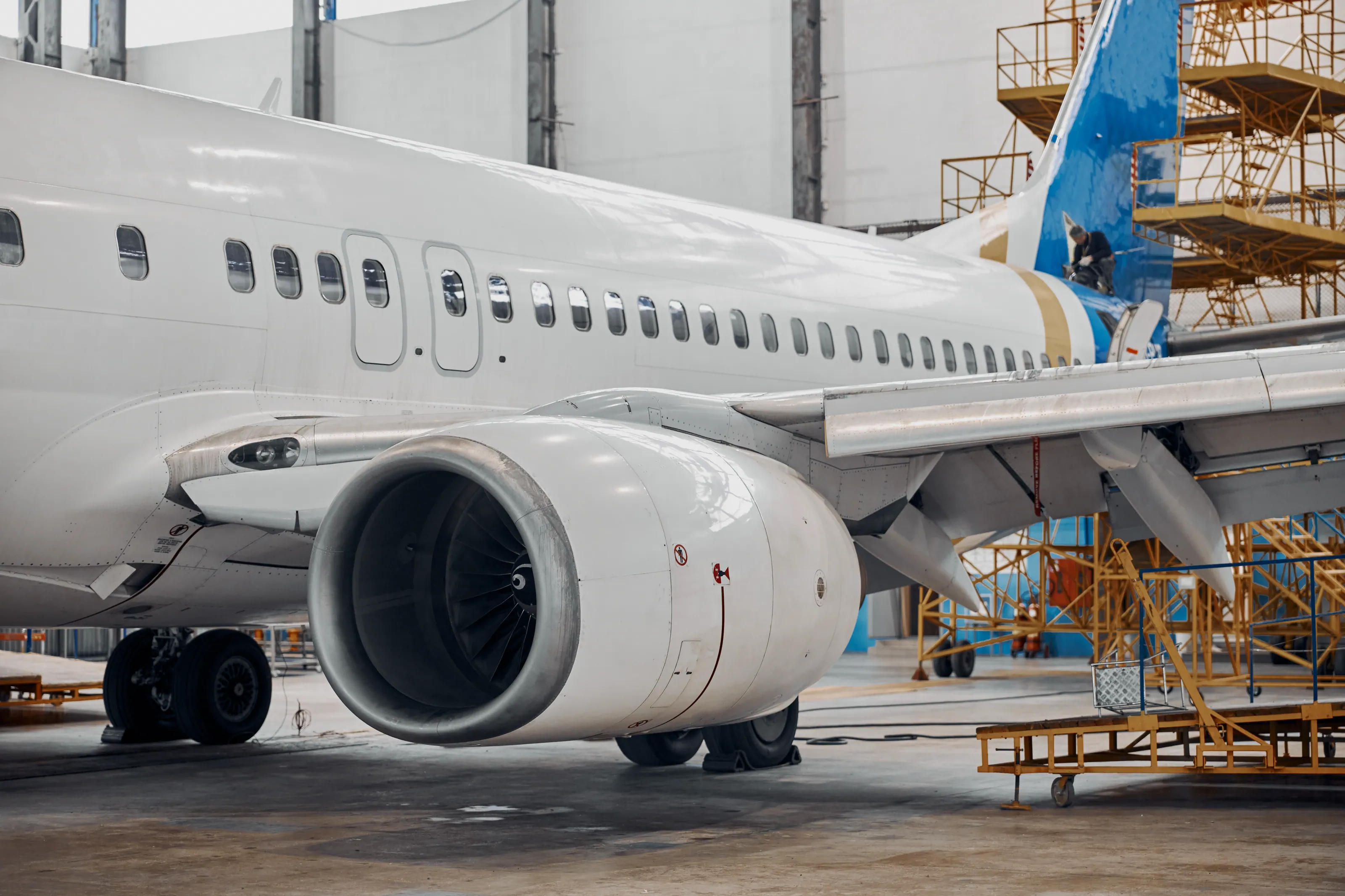 Aircraft undergoing service in a maintenance hangar